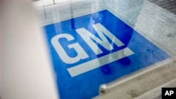 FILE - In this Thursday, Jan. 10, 2013 file photo, the logo for General Motors decorates the entrance to a former UPS facility as GM announced plans to open an information technology center in the building that would create about 1,000 jobs, in Roswell, G
