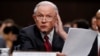 Attorney General Jeff Sessions reads from a statute about his recusal while testifying on Capitol Hill in Washington, June 13, 2017, before a Senate intelligence committee hearing. 