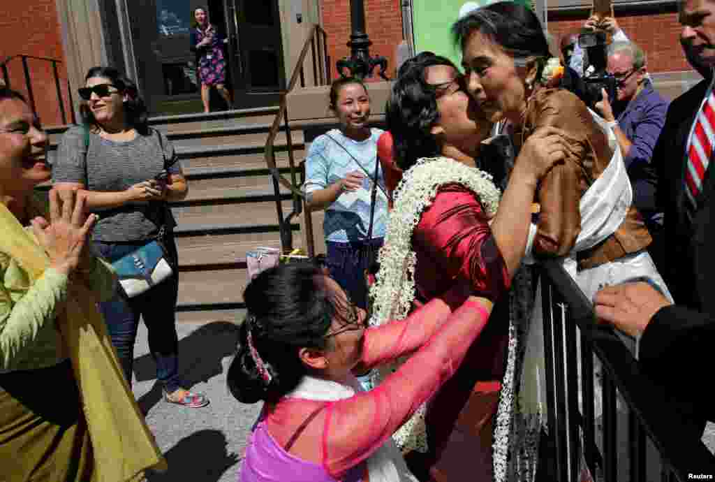 Supporters rush to greet and kiss Myanmar's State Counselor and Foreign Minister Aung San Suu Kyi outside the Blair House in Washington, D.C., where she had lunch meeting with U.S. Secretary of State John Kerry.