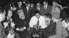 FILE - Muhammad Ali speaks to Muslims holding a book called "Towards Understanding Islam" written by Sayyid Abul Ala Maududi in London, May 1966. Ali died in Phoenix, Arizona, June 3, 2016.