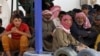 FILE - Syrian refugees wait to board a Jordanian army vehicle after crossing into Jordanian territory with their families, in al-Ruqban border area, near the northeastern Jordanian border with Syria, and Iraq, near the town of Ruwaished, 240 km (149 miles) east of Amman, Sept. 10, 2015.