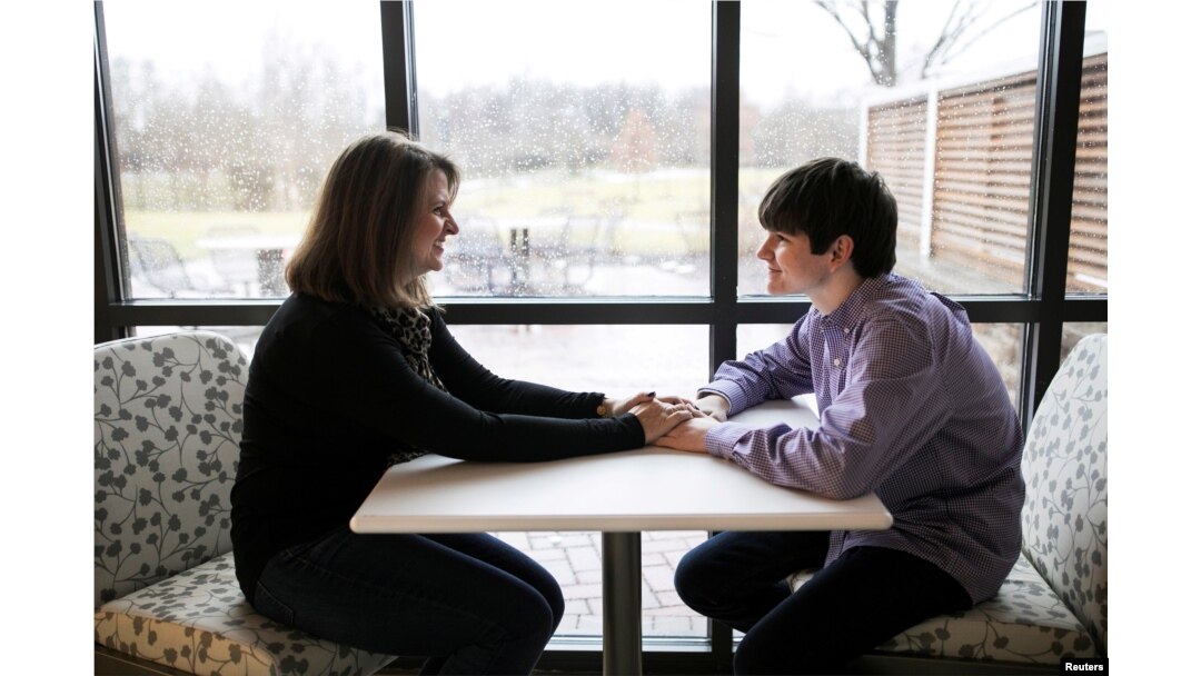 Danny Reagan, a former residential patient of the Lindner Center of Hope, sits in a common room with his mother Laurie Reagan at the center, in Mason, Ohio, Jan. 23, 2019.