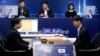 South Korean professional Go player Lee Sedol, right, prepares for his first stone against Google's artificial intelligence program, AlphaGo, as Google DeepMind's lead programmer Aja Huang, left, sits during the second match of the Google DeepMind Challen