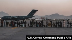 被疏散人士在喀布尔的哈米德·卡尔扎伊国际机场机场等待登机(2021年8月23日)
