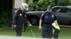 Dallas County Sheriff crime scene investigators use a metal detector at the intersection near where a black teenager was killed by a white police officer, May 3, 2017.