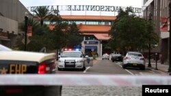 Police officers cordon off a street outside The Jacksonville Landing after a shooting during a video game tournament in Jacksonville, Florida, Aug. 26, 2018. 