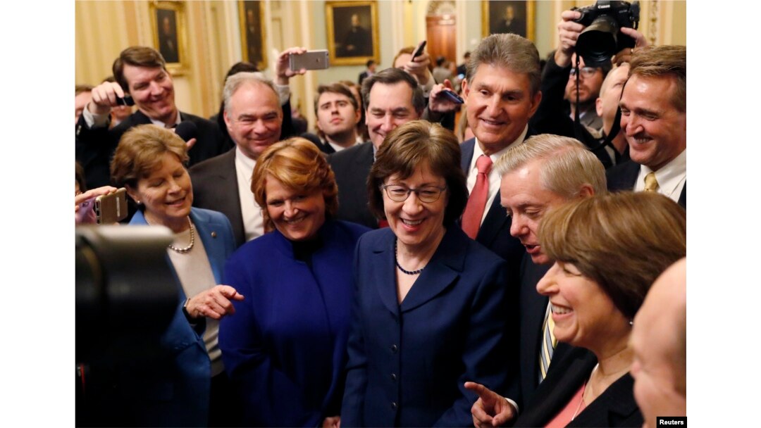 Senators' Susan Collins (R-ME) addresses reporters with fellow Senators' Jeanne Shaheen (D-NH), Tim Kaine (D-VA), Heidi Heitkamp (D-ND), Joe Manchin (D-WV), Lindsey Graham (R-SC), Amy Klobuchar (D-MN) and Jeff Flake (R-AZ) after lawmakers struck a deal to reopen the federal government three days into a shutdown on Capitol Hill in Washington, Jan. 22, 2018.