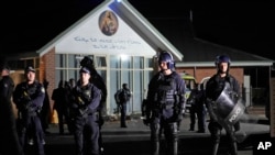 Security officers stand guard outside Orthodox Assyrian church in Sydney, Australia, April 15, 2024. 