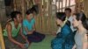 ဒေါ်အောင်ဆန်းစုကြည်နဲ့ ကမ္ဘာကျော်မင်းသမီး အင်ဂျလီနာဂျိုလီတို့ လှိုင်သာယာ ကျူးကျော်ရပ်ကွက်အတွင်းက တဲတလုံးကို သွားရောက်လည်ပတ်ပြီး သိလိုတာတွေကို မေးမြန်းခဲ့စဉ်။ (သြဂုတ် ၁၊ ၂၀၁၅)