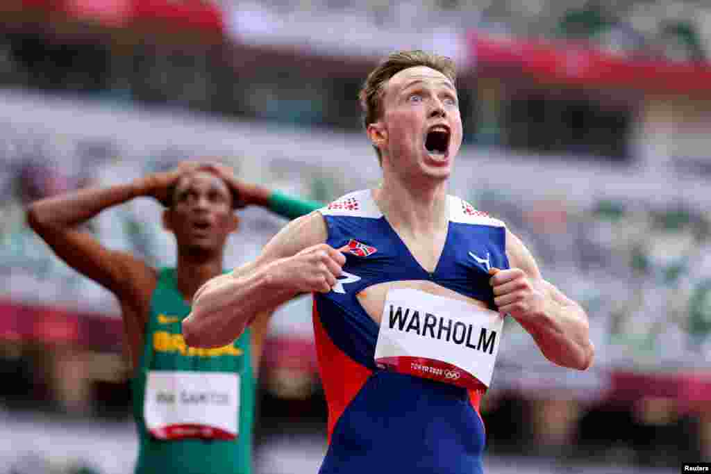 Karsten Warholm of Norway celebrates as he wins the gold medal in the final of the men's 400-meter hurdles at the 2020 Summer Olympics in Tokyo, Japan.