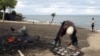 A fisherman prepares fish beside Lake Malawi, 120 km (75 miles) east of the capital Lilongwe, Malawi, April 3, 2009. 