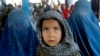 Afghan refugees wait for their documents to go back to Afghanistan at the UNHCR's Repatriation Center in Peshawar, Pakistan, June 23, 2016. 