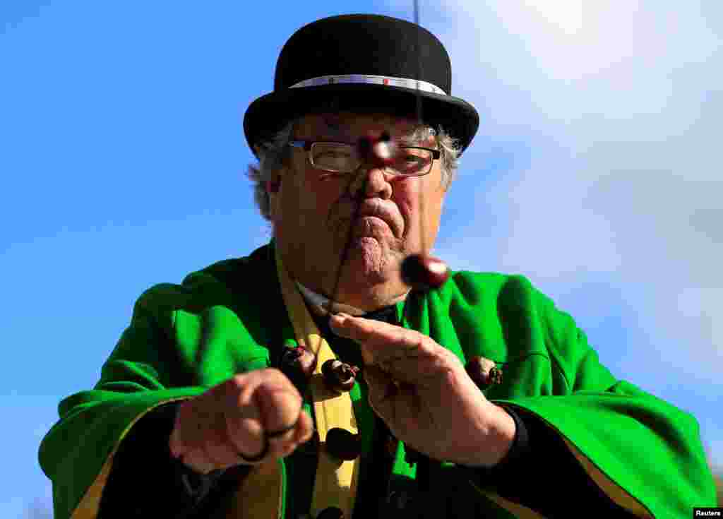 David Jakins, known as King Conker, swings his conkers during a match at the World Conker Championships, in Southwick, central England.