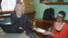 Mary Jana (right) one of few patients who collect sunsecreen from Simbota (left) dspites reports of kidnappings and killings. (Lameck Masina for VOA News)
