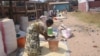 Maize rationing has forced private traders like these women to increase their prices, Karonga, Malawi. (Tiwonge Kumwenda/VOA)