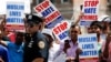 FILE - Community members take part in a protest to demand stop hate crime during the funeral service of Imam Maulama Akonjee, and Thara Uddin in the Queens borough of New York City, Aug. 15, 2016. 