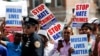 FILE - Community members take part in a protest against hate crimes during the funeral of Imam Maulama Akonjee and Thara Uddin in Queens, New York, Aug. 15, 2016. An attacker fatally shot the imam and his assistant on a street in Queens.