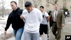 FILE - In this Jan. 11, 2018, photo, suspected members of the MS-13 gang are escorted to their arraignment in Mineola, N.Y.
