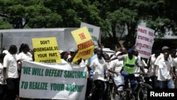 FILE - Supporters of the Zimbabwe African National Union's Patriotic Front (ZANU-PF) march in Harare, Feb. 24, 2010, to protest against a European Union decision to extend economic sanctions on Zimbabwe.