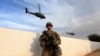 FILE - A U.S. Army soldier stands with his weapon at a military base in the Makhmour area near Mosul during an operation to attack Islamic State militants in Mosul, Iraq, Oct. 18, 2016.