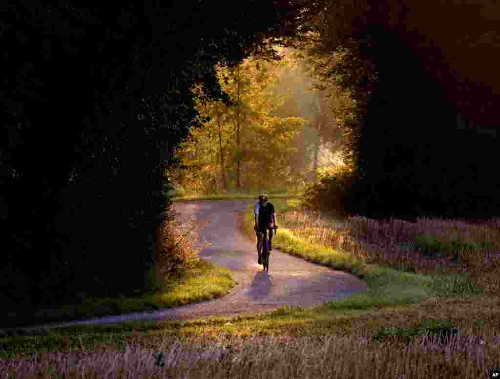 A man rides his bike on a small road in the outskirts of Frankfurt, Germany.