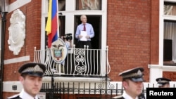 WikiLeaks founder Julian Assange steps onto the balcony before speaking to the media outside the Ecuador embassy in west London, August 19, 2012.