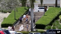 People arrive for a graduation ceremony for Marjory Stoneman Douglas High School seniors, June 3, 2018, in Sunrise, Florida. 