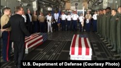 U.S. Defense Secretary Ash Carter, second left, with U.S. military members after they loaded the casket of what could be the remains of one to two crew members from a World War Two crash, in a C-17 aircraft, at Palam airport, in New Delhi, India, April 13