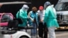 Empleados de salud ayudan a una paciente con síntomas de COVID-19 en la Ciudad de México.