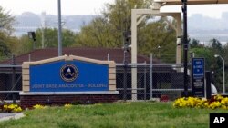 FILE - The gate for the Joint Base Anacostia-Bolling is seen in Washington, D.C., April 17, 2013. The base was one of the Washington-area sites that received suspicious packages Monday.