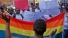 FILE - Women protest against a sentence of 14 years in prison, with hard labor, given to two men in Malawi under anti-gay legislation, in the city of Cape Town, South Africa, May 20, 2010. A high court in Malawi has ordered the annulment of a government moratorium issued in 2012 that suspended a law criminalizing homosexual acts.