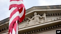 FILE - The front facade of the Robert F. Kennedy Department of Justice Building is seen in Washington, in a June 19, 2015, photo.