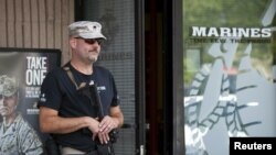 U.S. Army veteran Chris Murphy, armed with a rifle and handgun, stands near a U.S. Marines recruiting office in Everett, Washington July 23, 2015. According to the U.S. Army, citizens across the U.S. volunteered to station themselves near military recruiting centers to offer protection after the 2015 shooting in Chattanooga, Tennessee. 