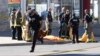 FILE - Firefighters stand near a covered body after a van struck multiple people at a major intersection northern Toronto, Ontario, April 23, 2018. The attacker was a self-identified incel — short for "involuntary celibate." 