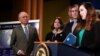 U.S. Attorney General Jeff Sessions listens to Angela Stancik (R) of Houston, Texas, speaking about her grandmother, a victim of fraud, during a news conference at the Department of Justice in Washington, Feb. 22, 2018. 