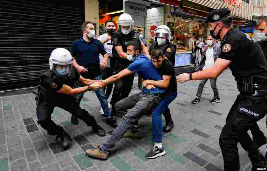 Police officers detain a demonstrator as he resists during a protest against the ban of this year's Peace Day rally, in Istanbul, Turkey, Sept. 5, 2021.