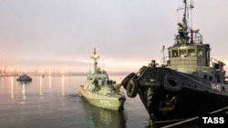 UKRAINE - Three ships of the Naval Forces of Ukraine artillery boats "Nikopol", "Berdyansk" and raid tug "Yani Kapu" (from left to right), towed to the city port, on November 26, 2018.