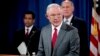 Attorney General Jeff Sessions, accompanied by, from left, National Counterintelligence and Security Center Director William Evanina, Director of National Intelligence Dan Coats, speaks during a briefing at the Justice Department in Washington, Aug. 4, 20