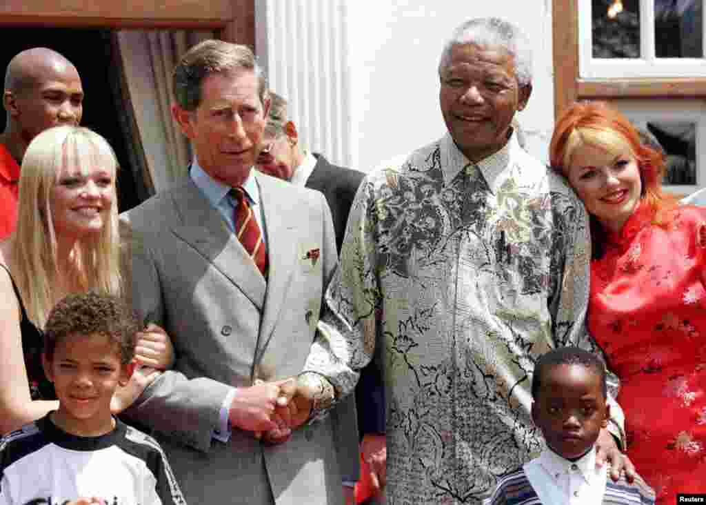 President Nelson Mandela and Britain's Prince Charles shake hands alongside members of the Spice Girls' Emma (L), and Gerri (R) at Mr. Mandela's residence November 1, 1997.