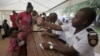 Refugees fleeing anti-immigrant violence are processed by immigration officers at a transit camp in Beit Bridge, ZImbabwe, April 24, 2015.