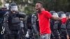 FILE - A protester yells at police in front of the Baton Rouge Police Department headquarters after police arrived in riot gear to clear protesters from the street in Baton Rouge, Louisiana, July 9, 2016.