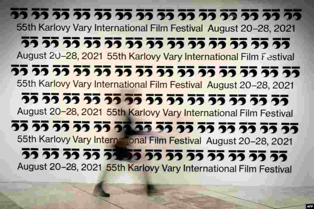 A film fan walks past a banner during the 55th Karlovy Vary International Film Festival (KVIFF) in A film fan walks past a banner during the 55th Karlovy Vary International Film Festival (KVIFF) in Karlovy Vary, Czech Republic.