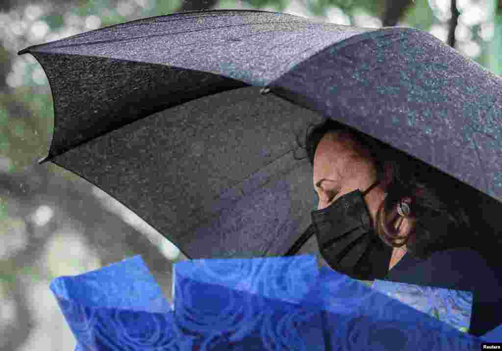 U.S. Vice President Kamala Harris lays flowers at Senator John McCain's memorial site, where his Navy aircraft was shot down by the North Vietnamese in Hanoi, Vietnam, on the three-year anniversary of his death.