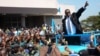FILE - Newly elected Malawian President Peter Mutharika greets supporters after he was sworn in at the High Court in Blantyre, May 31, 2014.