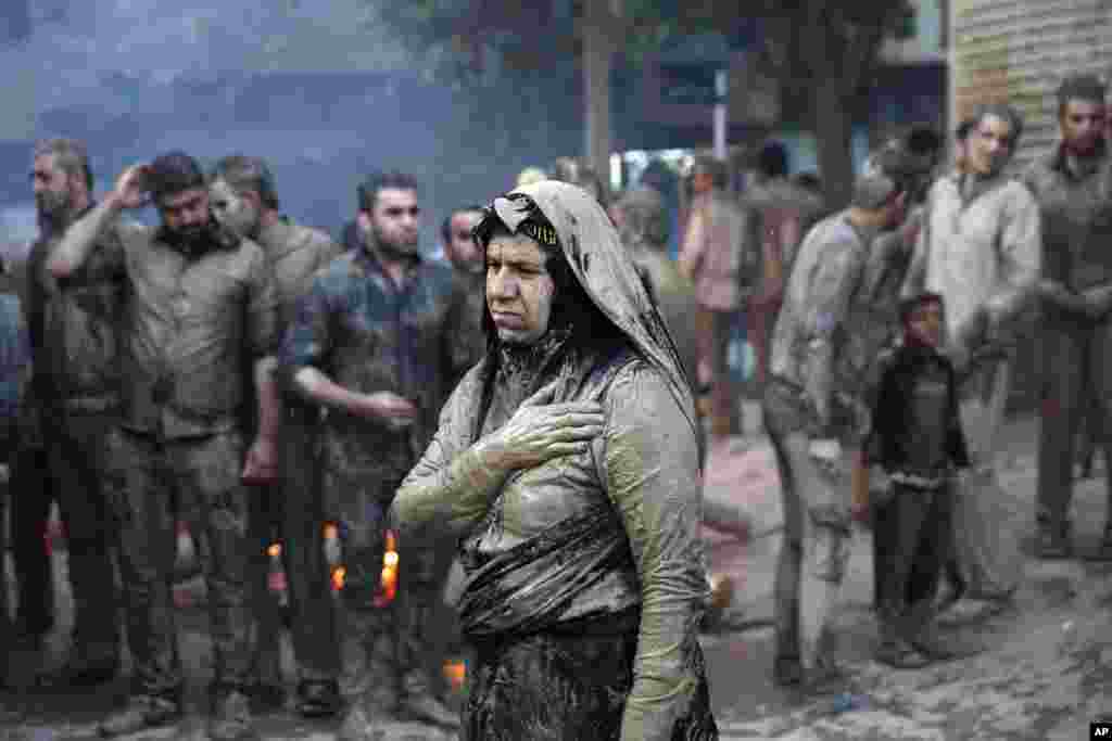 Iranian Shi'ite Muslims mourn after covering themselves with mud during Ashoura rituals, in Khorramabad. Shi'ites mark Ashoura, the 10th day of the Muslim month of Muharram, to commemorate the martyrdom of Imam Hussein, a grandson of Prophet Muhammad and one of Shiite Islam's most beloved saints, during the 7th century Battle of Karbala in present-day Iraq.