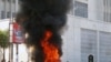 A protester burns vegetation in a street in Lilongwe, Malawi, Wednesday, July 20, 2011