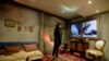 FILE - A woman watches video inside a mock Syrian home, set up by Amnesty International at a subway station in Buenos Aires, Argentina, Sept. 19, 2016. Argentina's President Mauricio Macri pledged his country would accept 3,000 Syrian refugees.