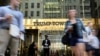 FILE - A doorman stands as people walk past Trump Tower in New York, May 23, 2016.