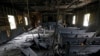 FILE - Burned pews and destroyed musical instruments, Bibles and hymnals are part of the debris inside the fire-damaged Hopewell M.B. Baptist Church in Greenville, Mississippi, Nov. 2, 2016. 