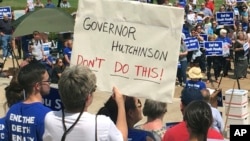 Protesters gather outside the state Capitol building, April 14, 2017, in Little Rock, Ark., to voice their opposition to Arkansas' seven upcoming executions.